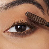 Model Applying Brown Mascara