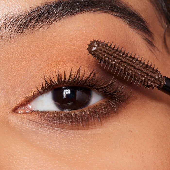 Model Applying Brown Mascara
