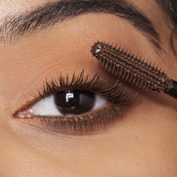 Model Applying Brown Mascara