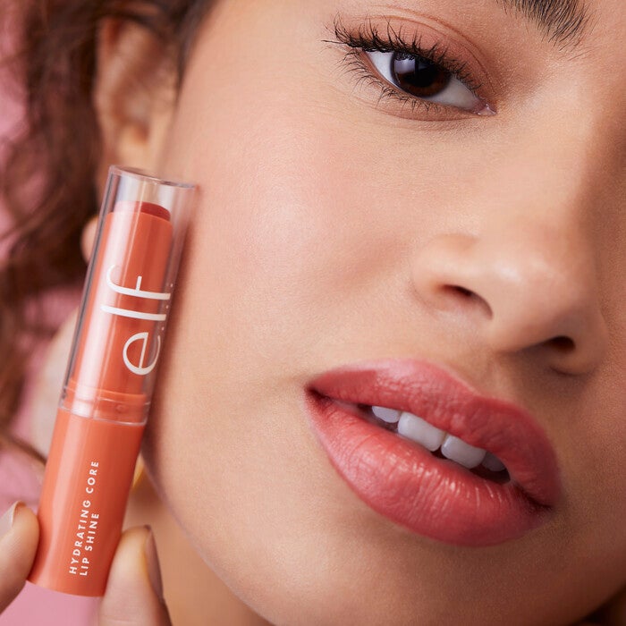 Model Holding Joyful Core Lip Shine