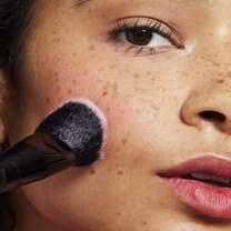 Model Applying Liquid Blush with Stain and Tint Blending Brush