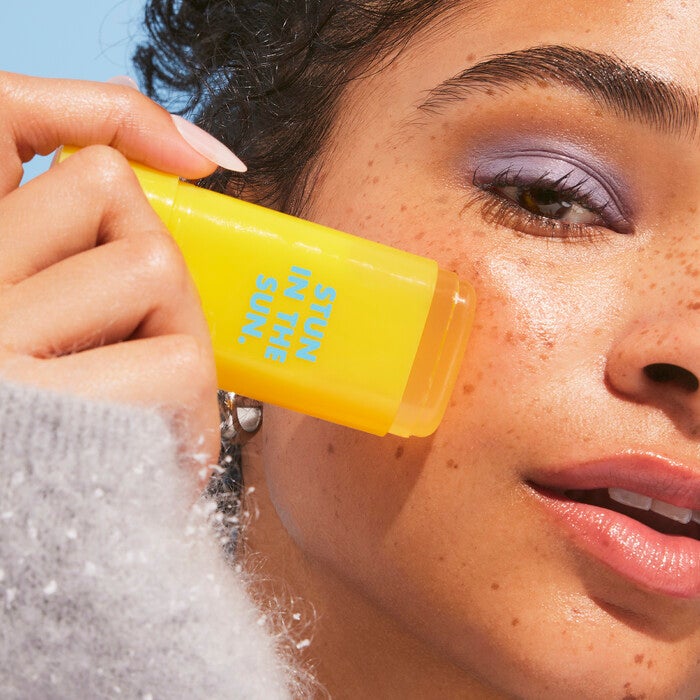 Applying Suntouchable Invsible Sunscreen Stick 
