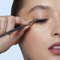 Model Applying False Eyelashes with Applicator