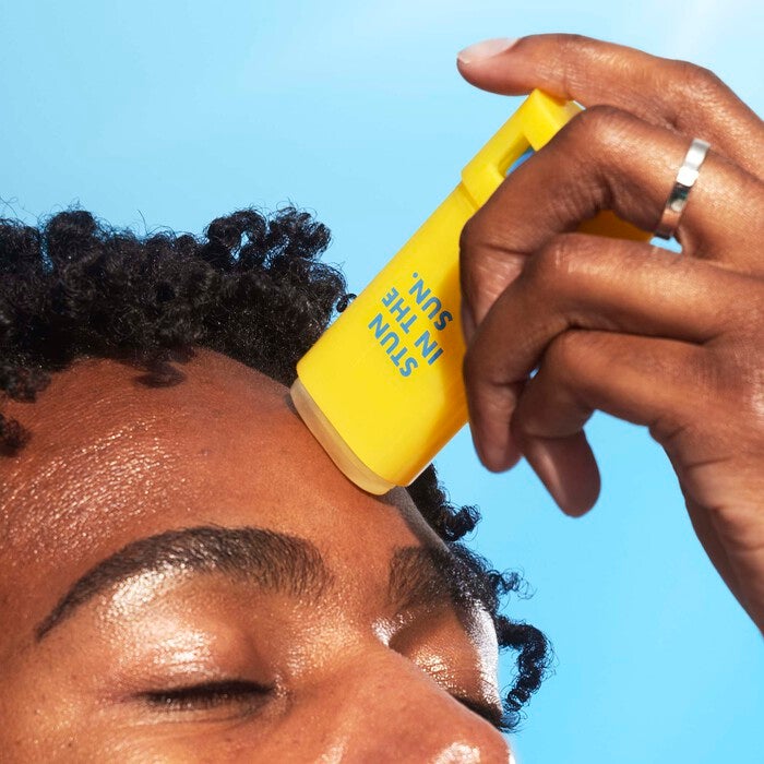 Mikel Applying Invisi-Stick Clear Sunscreen