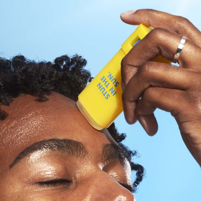 Mikel Applying Invisi-Stick Clear Sunscreen