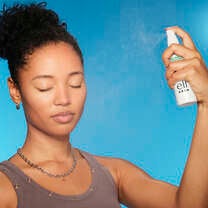Woman spraying Hypochlorous Acid Spray on Face
