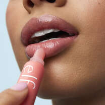 Model Applying Strawberry Lip Balm