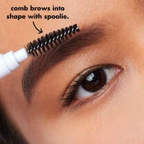 Model Using Spoolie to Shape Brows